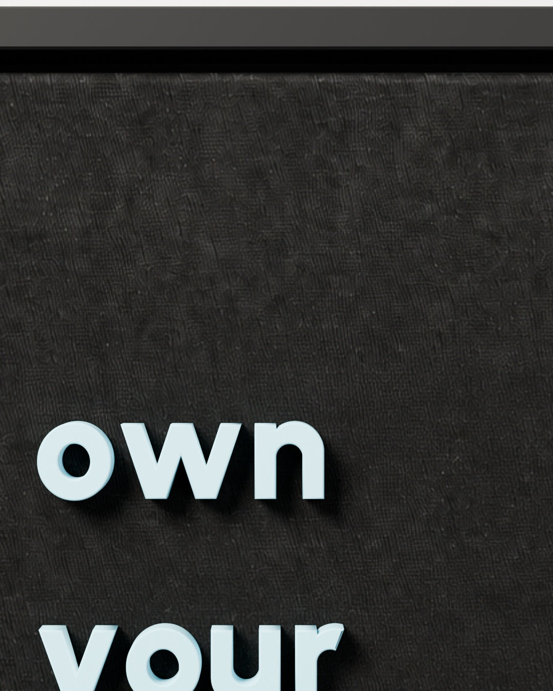 own your space — black woven fabric and raised lettering close-up
