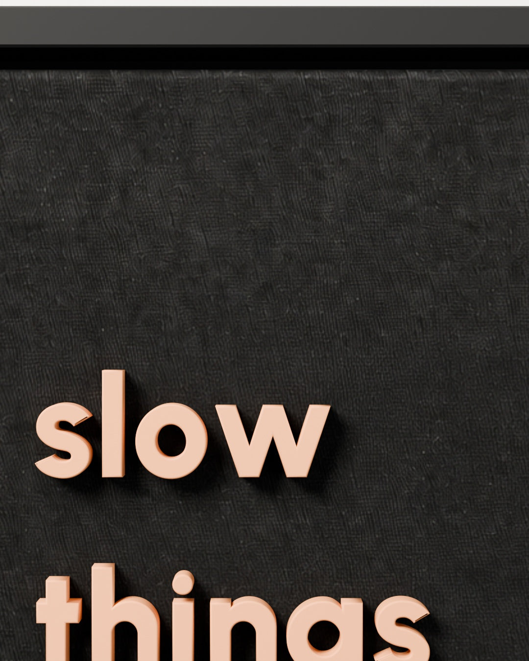 slow things down — black woven fabric and raised lettering close-up