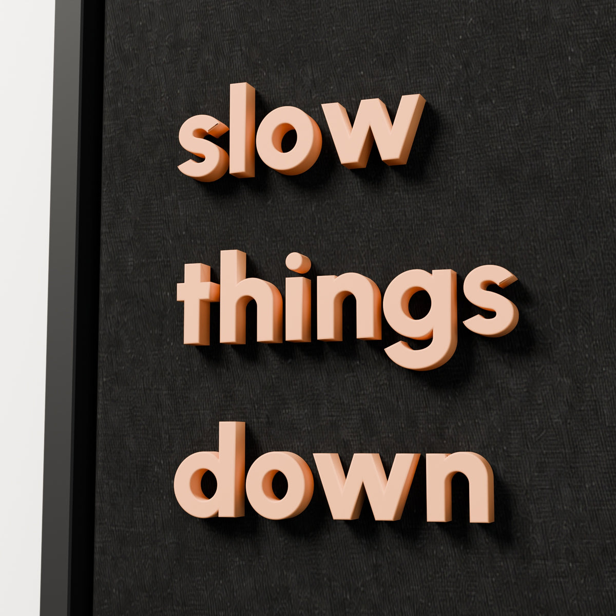 slow things down — black frame, raised lettering detail